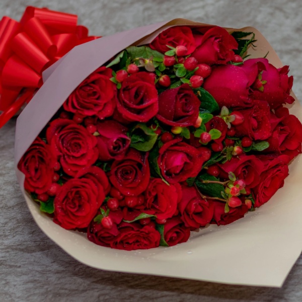 red roses berries bouquet