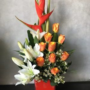 white lilies orange roses vase