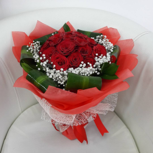 12 red roses with gypsophila around