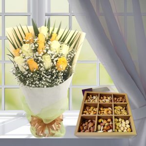 Yellow white roses bouquet andnuts box